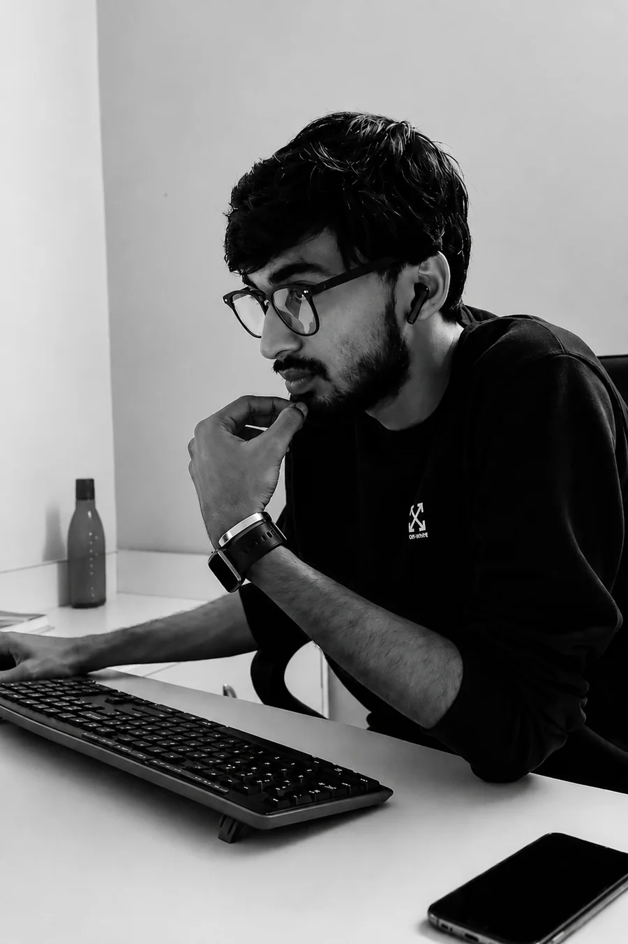 Noor, founder of EazyLimo, at a desk working on a website
